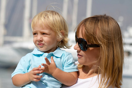  son having fun, while their dad is taking photos with his DSLR 