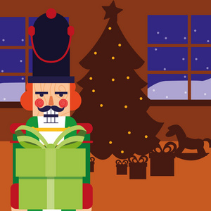 圣诞胡桃夹子拿着礼物盒与树图片