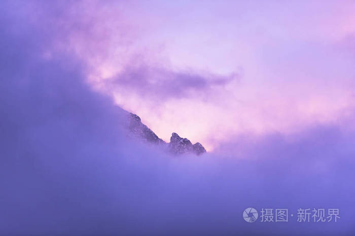 紫色的天空山顶覆盖着云彩