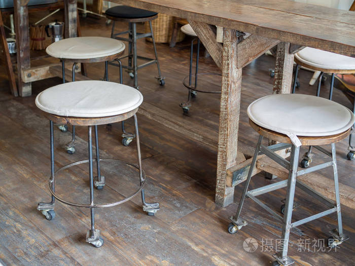 旧的老式铁和木条凳子与车轮与黑白织物垫在顶部和木桌在木地板在咖啡馆装饰复古风格 照片 正版商用图片163acr 摄图新视界