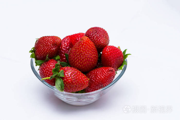 玻璃碗里装满了白色背景的红色草莓