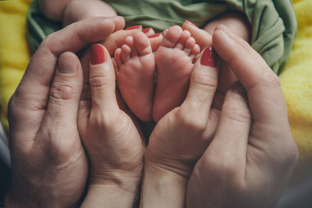 s feet.Mother holding newborn baby legs,legs massage