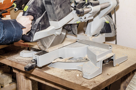 s machine with circular saw, man cuts the board. Work process, e