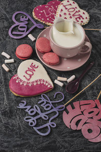 s Day breakfast. Heartshaped cookies and a cup of milk on a gra