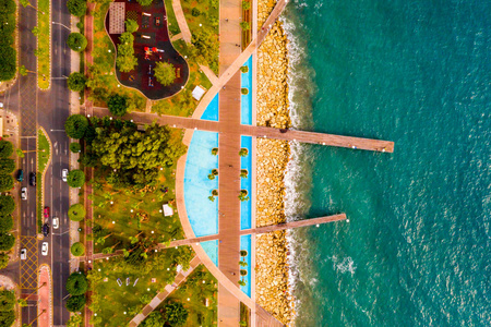 s eye view of the jetty, beachfront walk path and palm trees by 