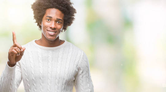 美国黑人男子在孤立的背景上显示和指向第一手指，同时微笑自信和快乐。
