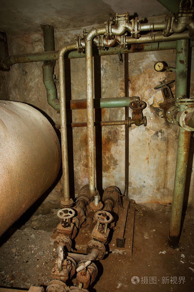 工业建筑的废弃内部. 旧损坏的锅炉房. 旧生锈的管子.