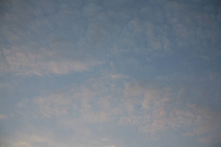 s rays illuminate the images of the sky with clouds