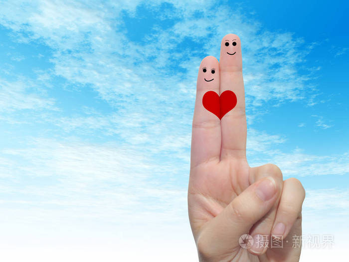 概念或概念人类或女性的双手用两个手指涂着红色的心在云蓝色的天空