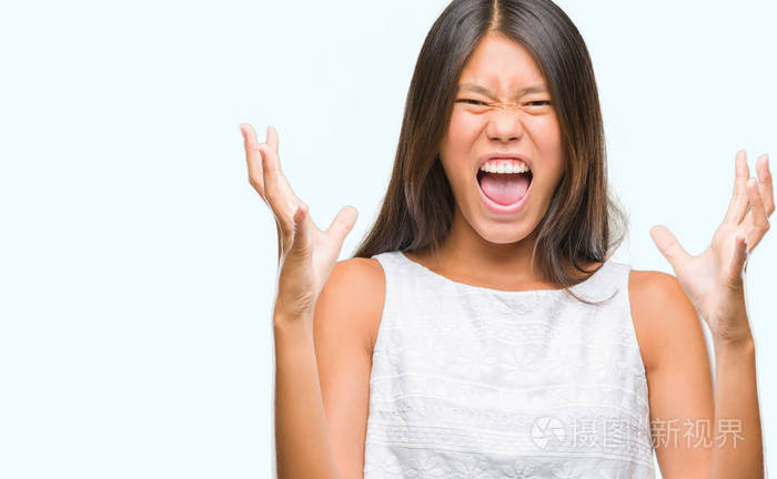 年轻的亚洲女人在孤立的背景下疯狂和疯狂地大喊大叫,带着咄咄逼人的
