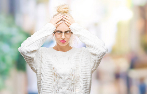 年轻漂亮的金发女人戴着眼镜，在孤立的背景下患有头痛，绝望和压力，因为疼痛和偏头痛。 手放在头上。