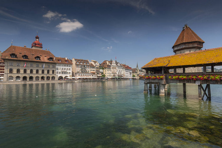 在瑞士卢肯市，旧城镇的景色与市政厅和礼拜堂桥木人行桥横跨Reuss河。