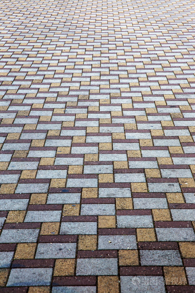 美丽的背景铺设了人行道上的铺路板. 单调的多色釉面铺板图案.