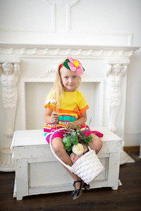 s Day. Joyful and cheerful child. White basket with flowers. Smi