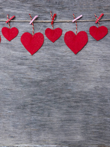 s love hearts on natural cord and pink pins hanging on rustic te