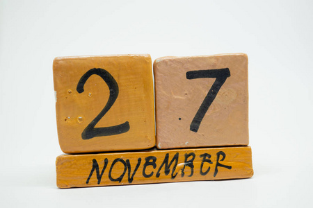 十一月二十七日。 月27日手工木历隔离在白色背景上。 秋月一年的概念。