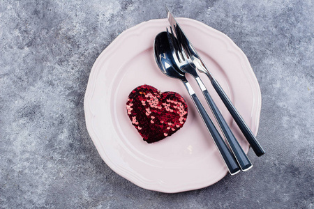 s Day with cutlery and hearts on a stone table background. Space