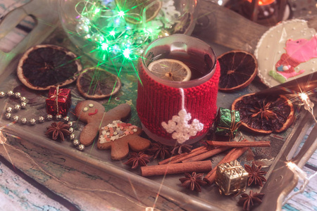 s still life with mug of tea with knitted cup cover, cookies, ch