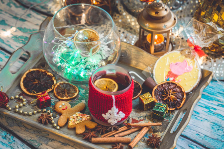 s still life with mug of tea with knitted cup cover, cookies, ch