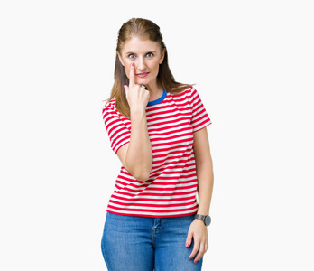 中年成熟的女人穿着休闲t恤,背景偏僻,眼睛盯着你看,手势可疑的表情