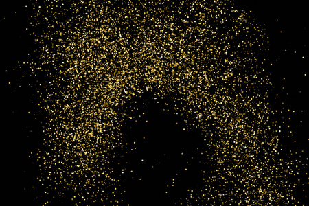 金色闪光的纹理隔离在黑色上. 琥珀颗粒的颜色. 庆祝背景.