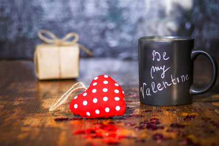 s day concept with black cup, chalk inscription on a mug and a r