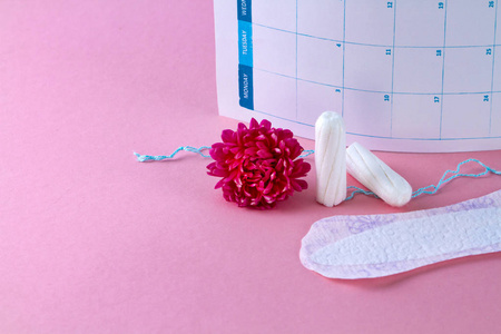 s calendar and flowers on a pink background. Hygiene care during