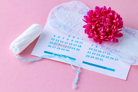 s calendar and flowers on a pink background. Hygiene care during