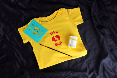 s tshirts with handmade drawing. Yellow fabric on a dark backgr