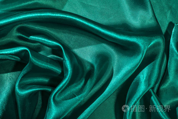 绿色缎子织物的背景闪亮的绿色丝绸背景