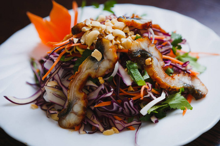  eel stripes on white plate.Tasty Vietnamese saald close up.Colo