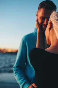 s face, couple in love on pier, sunset time, selective focus