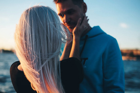 s face, couple in love on pier, sunset time, selective focus