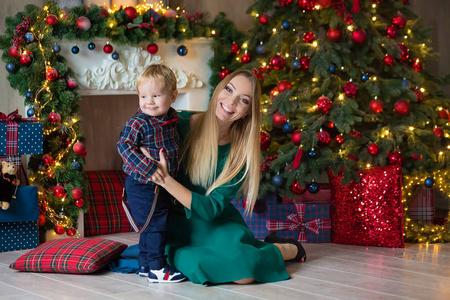 s holidays. Toddler with mom in the festively decorated room wit