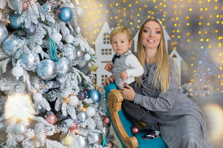 s holidays. Toddler with mom in the festively decorated room wit