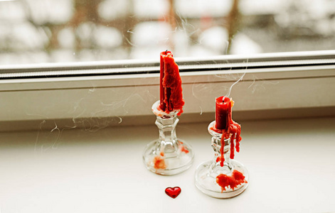 s red candles on the windowsill. Holiday greeting card.