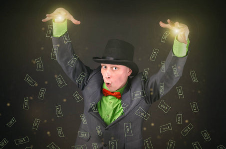 戴着圆顶礼帽的魔术师正在施魔法,从他的手上掉了一块钱在黑色背景上.