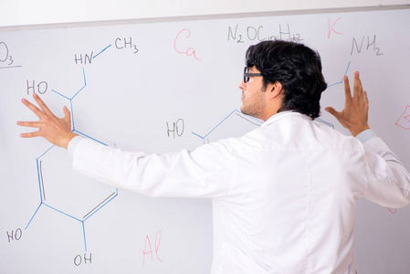年轻有趣的化学家在白板前