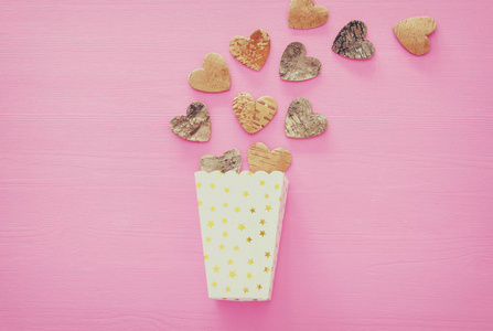 s day concept. wooden hearts over pink background. Flat lay