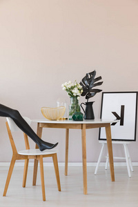 s leg on wooden chair in elegant dining room interior with copy 