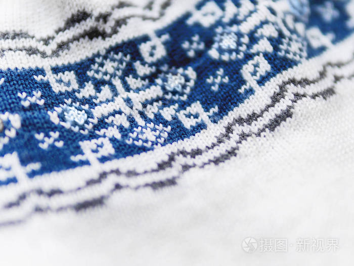 蓝色雪花针织北欧图案具有传统斯坎迪纳维亚装饰的织物保暖外套