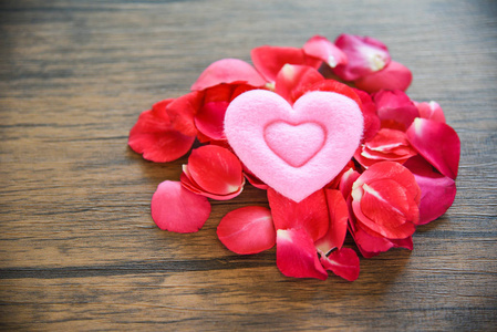 情人节爱心概念玫瑰花瓣粉心装饰在木桌上乡村背景