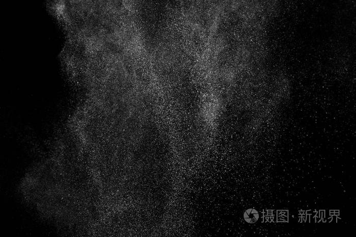 黑色背景上白色粒子的冻结运动.粉末爆炸.抽象粉尘覆盖纹理.