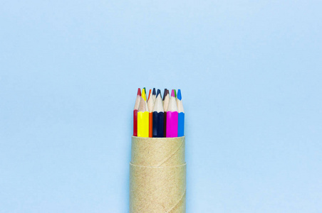 彩色铅笔在铅笔盒上的蓝色背景顶部视图平面与复制空间。 木制彩色铅笔，用于绘制创意物品，学校用品关闭。 回到学校的概念