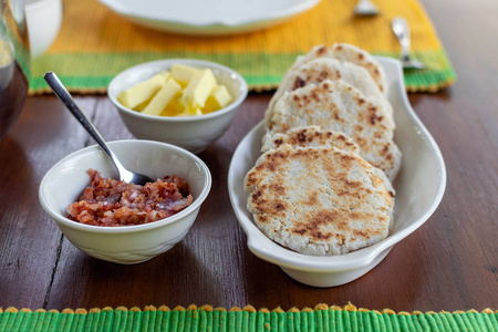传统的SRI兰坎椰子和罗蒂平面包，黄油和鲁努米里斯蘸红葱和辣椒。