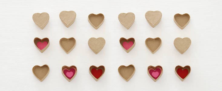 s day concept. hearts as paper gift boxes over wooden white back