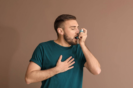 吸入器患哮喘的年轻人，颜色背景