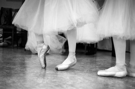 s legs in the dance hall. Black and white photography.