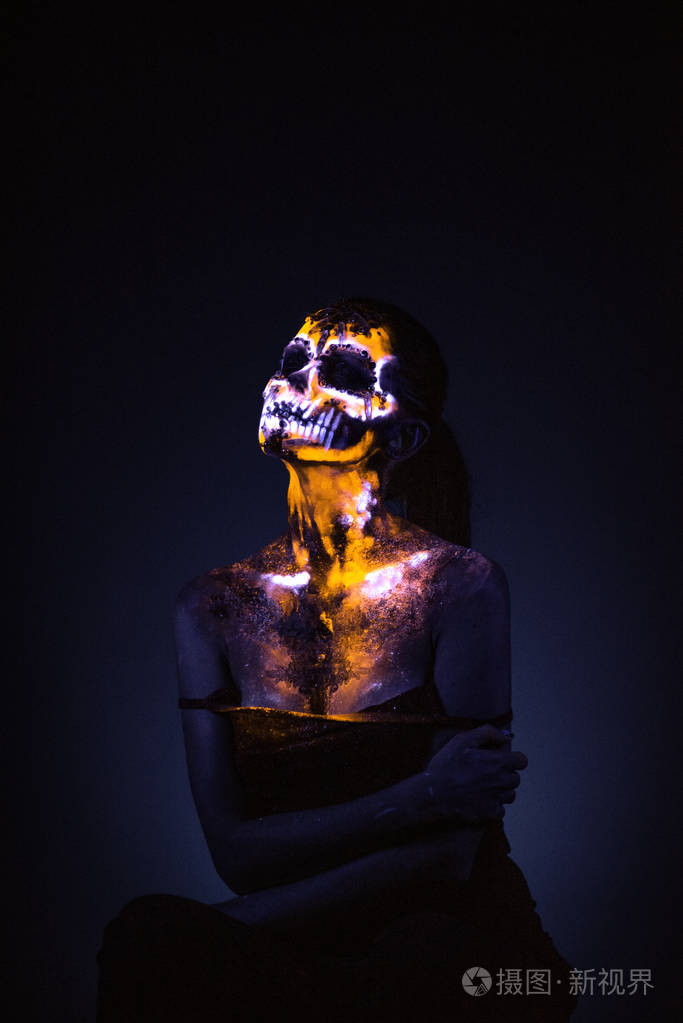 s face painted in fluorescent uv colors and looks like neon glow