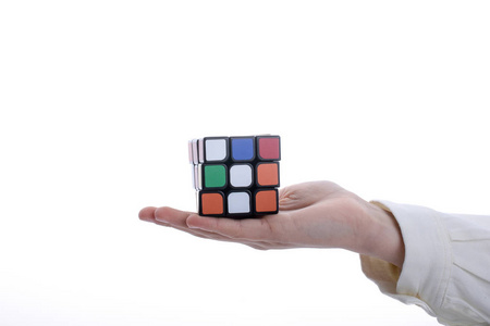 s cube in hand on a white background